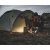 Setesdal 2 dome tents in a natural environment, one person cooking in front of the tent in the dark with a cozy atmosphere.
