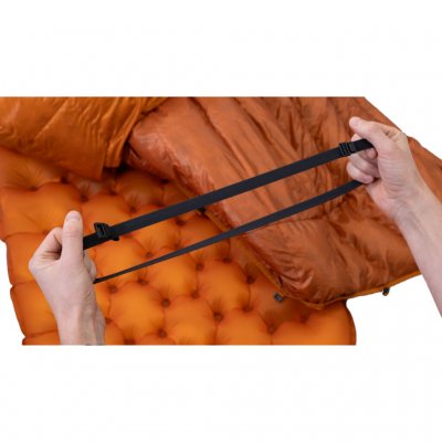Quilt with an open underside that can be attached to the sleeping pad.