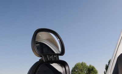 The rearview mirror is mounted in the original mirror frame with a core mount.