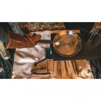A floor protector placed under the tent stove to protect the tent floor from heat, sparks, and small glowing embers.