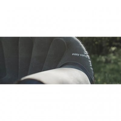 The armchair features wide armrests.