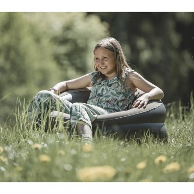 The armchair’s soft velour seat and wide armrests provide excellent comfort.