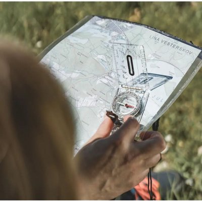 The compass has a rotating bezel and a large magnifying lens.