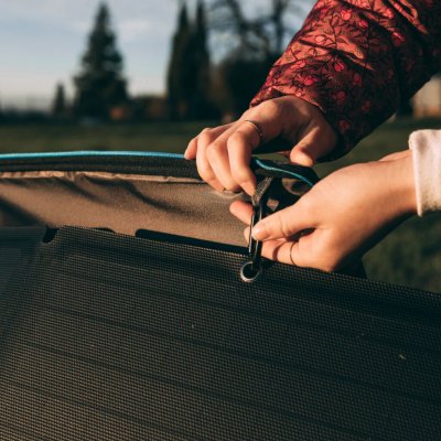 The solar panel attached to the bag with snap hooks
