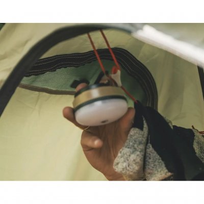 The lamp has a hanger that makes it easy to hang up and use as a ceiling light in the tent.