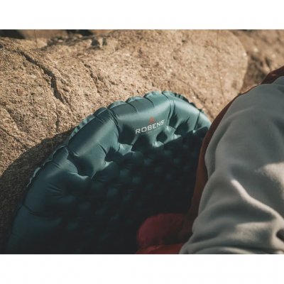 Inflatable sleeping mat in an ultra-lightweight construction.