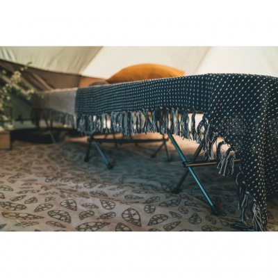 The tent carpet insulates against cold from the ground.