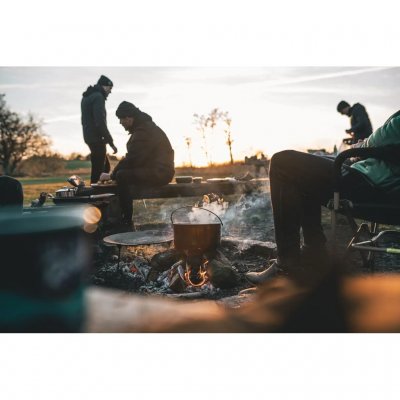 A 4-liter stainless steel pot with a handle featuring an attachment point for hanging over the fire.